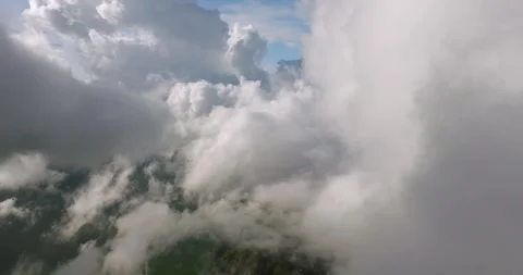 A sky filled with fluffy white cumulus clouds over a natural landscape Stock Footage 275003003