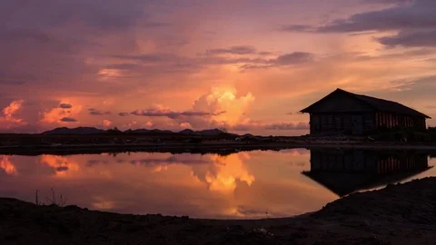 Sky fire. Reflections in the salt fields od South East Asia's monsoon season. Stock Footage 80626215