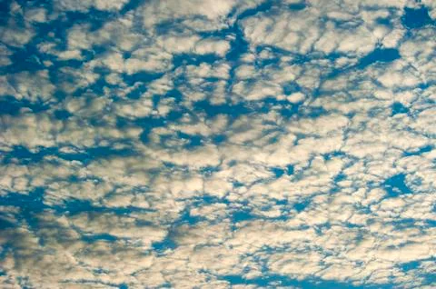 Sky with fluffy clouds lit bij the sun Stock Photos
