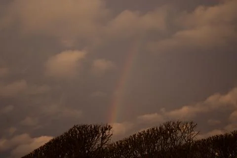 The sky full of clouds after the rain, the appearance of the rainbow and th.. Stock Photos