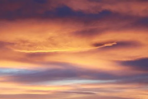 Sky full of clouds of different colors in a sunset Stock Photos