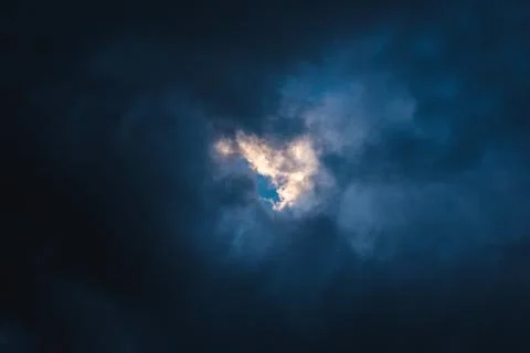 Sky glimpsed by gray clouds to form a heart Stock Photos
