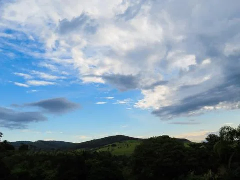 Sky landscape with clouds in fields at dusk. Stock Photos