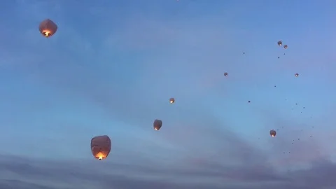 Sky lanterns floating away at dusk Stock Footage 77808537