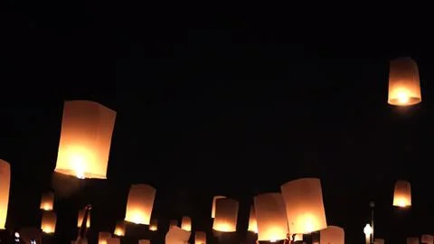 Sky lanterns floating at night with dark sky background Stock Photos