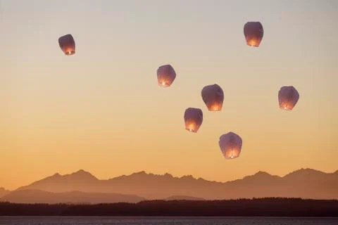 Sky lanterns flying upwards. Stock Photos