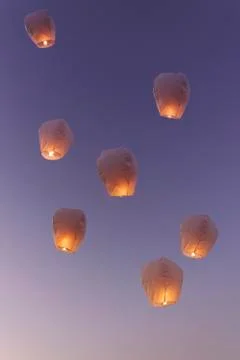 Sky lanterns flying upwards. Stock Photos