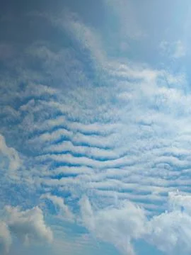 Sky Layers: Serene Cloudscape with Unique Formations Stock Photos
