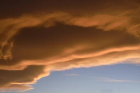 Sky light after sunset. orange background. Clouds. Stock Photos