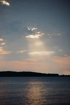 Sky with light clouds over the sea. Beautiful sunset on a summer evening. Shi Stock Photos