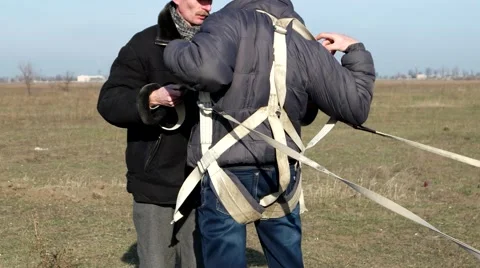 Sky The man puts equipment for parachuting Stockbeeldmateriaal 59189188