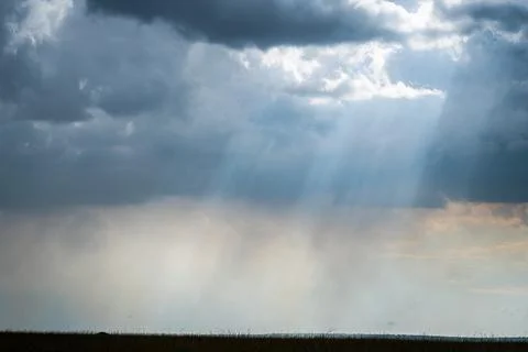 The sky is mostly cloudy with several white clouds scattered Foto stock