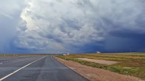 The sky is overcast, and a thunderstorm is raging in the distance Stock-Footage 317386480