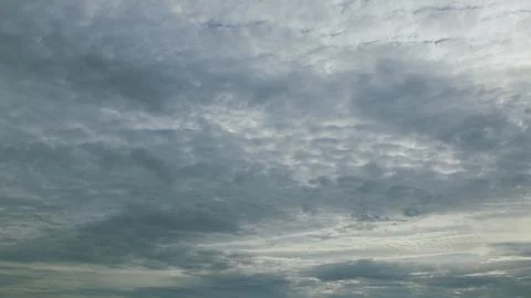 The sky is overcast with a textured cloud formation, creating an intriguing atmo 写真素材