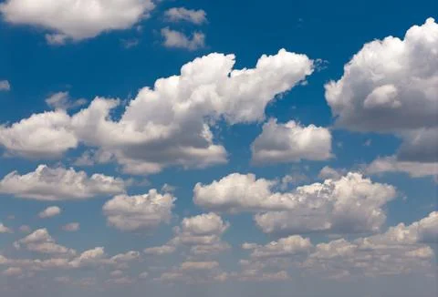 Sky pattern with fluffy clouds. Sunny sky carries white clouds. Blue sky ho.. Stock Photos