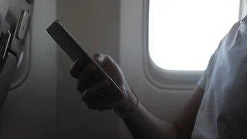 In sky phone is held by hand during the flight by airplane. Stock Footage 85556910