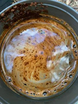 The sky is reflected in a coffee mug. A close up of a bowl.Fancy coffee patterns Fotos de archivo