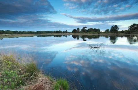 Sky reflected in river water Stock Photos