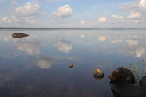 The sky is reflected in shallow backwater Stock Photos