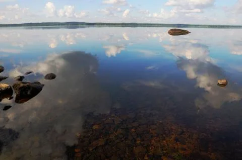 The sky is reflected in shallow backwater Stock Photos