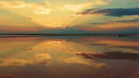 The sky is reflected in a smooth lake at sunset Stock Footage 146321926