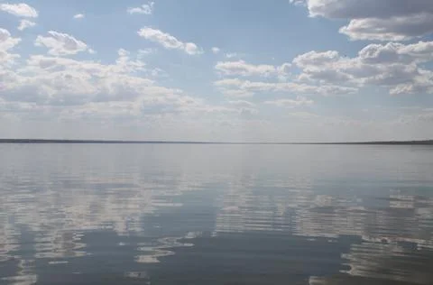 The sky reflected in the water, deserted beach lake, summer sky, nature, blue Stock Photos