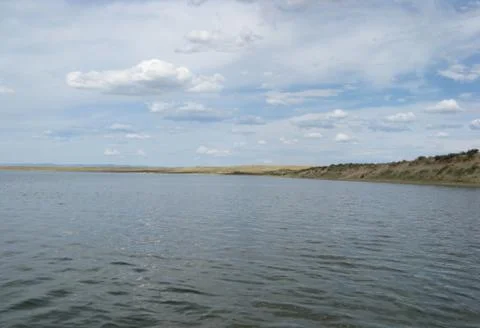 The sky reflected in the water, deserted beach lake, summer sky, nature, blue Stock Photos