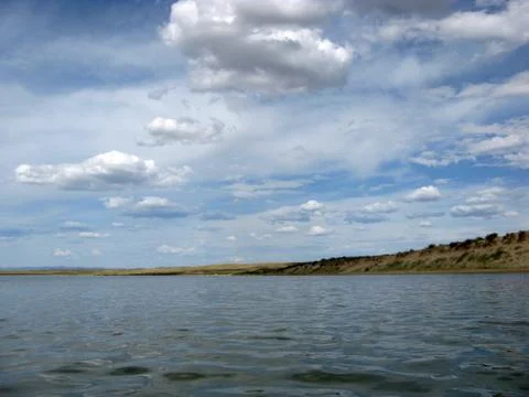 The sky reflected in the water, deserted beach lake, summer sky, nature, blue Stock Photos