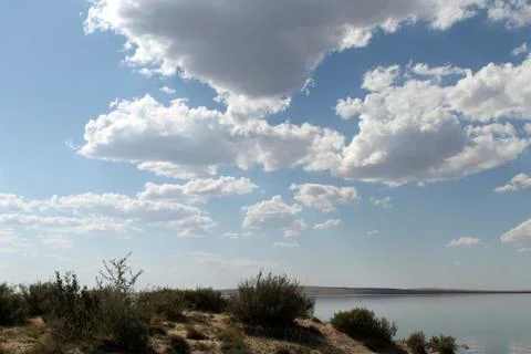 The sky reflected in the water, deserted beach lake, summer sky, nature, blue Stock Photos