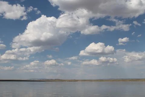 The sky reflected in the water, deserted beach lake, summer sky, nature, blue Stock Photos