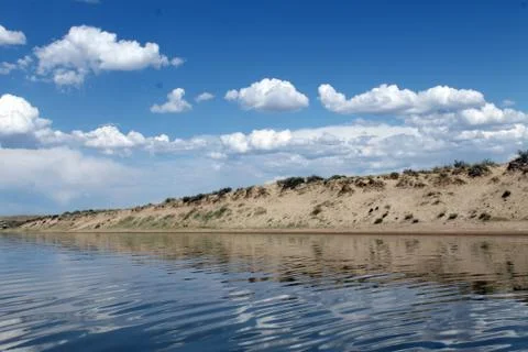 The sky reflected in the water, deserted beach lake, summer sky, nature, blue Stock Photos