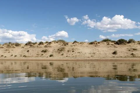 The sky reflected in the water, deserted beach lake, summer sky, nature, blue Stock Photos