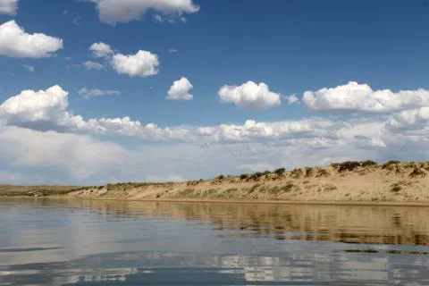 The sky reflected in the water, deserted beach lake, summer sky, nature, blue Stock Photos