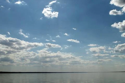 The sky reflected in the water, deserted beach lake, summer sky, nature, blue Stock Photos