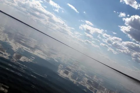 The sky reflected in the water, deserted beach lake, summer sky, nature, blue Stock Photos