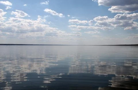 The sky reflected in the water, deserted beach lake, summer sky, nature, blue Stock Photos