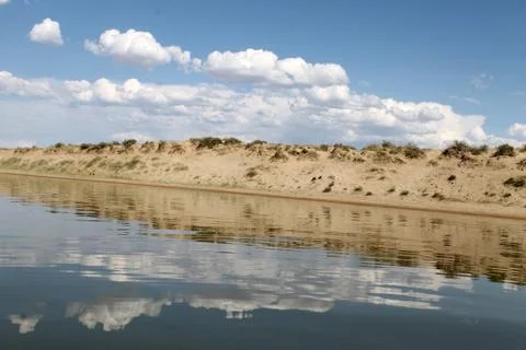 The sky reflected in the water, deserted beach lake, summer sky, nature, blue Stock Photos