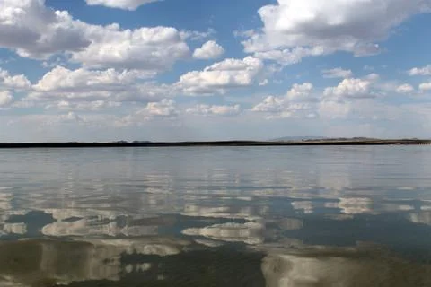 The sky reflected in the water, deserted beach lake, summer sky, nature, blue Stock Photos