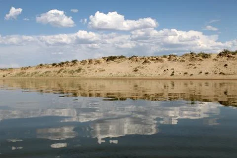 The sky reflected in the water, deserted beach lake, summer sky, nature, blue Stock Photos