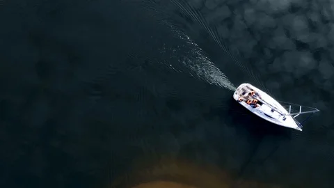The sky is reflected in the water. Top view aerial footage of a white yacht Stock Footage 107082797