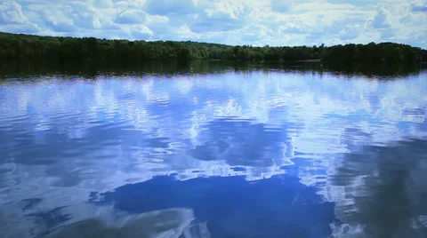 Sky reflection in clear lake Video stock 31470751