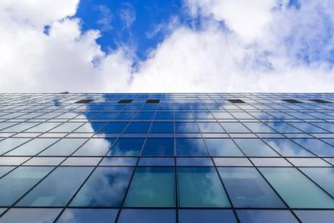 Sky reflection on glasses of the building Stock Photos