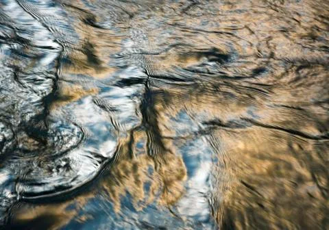 Sky reflection in rippling water surface Stock Photos