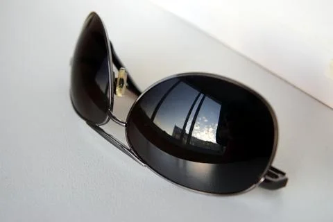 Sky reflection in sunglasses Stock Photos