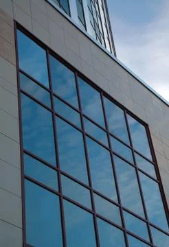 Sky reflection in the windows of the office building Stock Photos