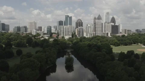 Sky reflects off pond by city Stock Footage 160994591