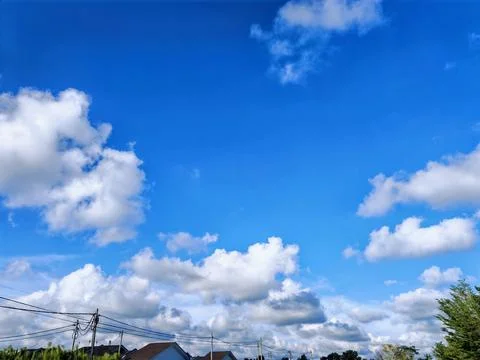Sky with Rooftops and Power Lines Stock Photos