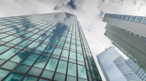 Sky scrapers. Fast moving clouds. Windows reflections Stock Footage 68685659