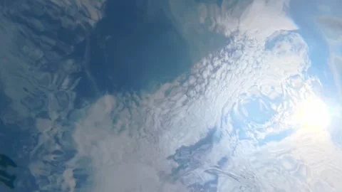 Sky seen through rippling water surface from underwater perspective Stock Footage 342161977