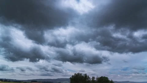 The sky shifts dramatically as thick clouds roll in, creating contrasting Stock Footage 284600751
